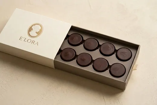 The sliding box with the drawer pulled out, eight chocolates in a two by four insert